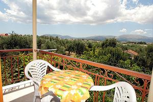 a table and chairs on a balcony with a view at 8 KEYS by Katerina in Kalamaki