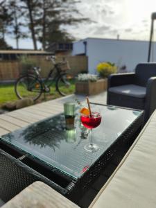 a tray with a glass of wine on a table at Hôtel Restaurant La Voile Bleue in Erdeven