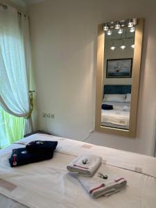 a bedroom with a bed with two bags and a mirror at Casa Ivi in Monastiraki