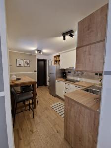 a kitchen with a wooden table and a tableasteryasteryasteryasteryasteryasteryastery at Little Oasis in Šibenik