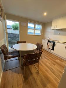 a kitchen and dining room with a table and chairs at Birch Court - Harakeke in Whanganui