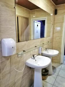 a bathroom with two sinks and a mirror at Sweet Home in Dnipro