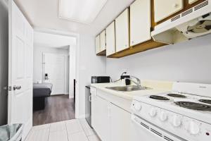 a white kitchen with a sink and a stove at South Seas Ocean Front in Myrtle Beach