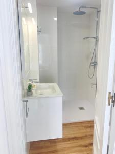 a white bathroom with a sink and a shower at OH LA LIFE MAR in Portosin