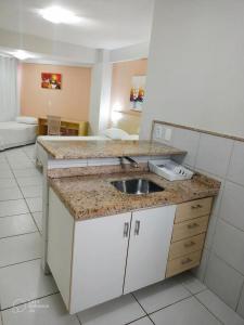 a kitchen with a sink and a counter at Marsallis Praia JR 406 in Natal