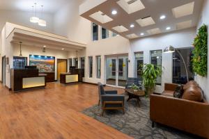 an office lobby with a couch and chairs at Wingate by Wyndham Valdosta/Moody AFB in Valdosta