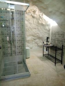 a bathroom with a shower in a cave at Cave house in Heraklio