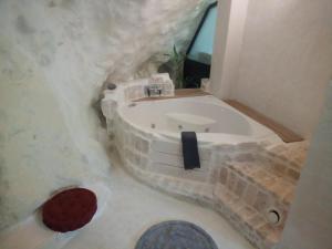 a bathroom with a bathtub made out of stone at Cave house in Heraklio Town