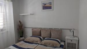 a bedroom with a bed and a lamp on a table at Apartma Ela in Koper