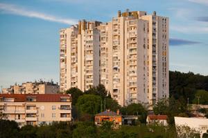 a large white apartment building in a city at Adria Vista Mare - Modern Apartment with Sea View in Pula