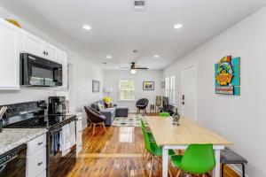 a kitchen and living room with a table and green chairs at 323 W Zarragossa in Pensacola