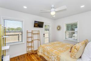 a bedroom with a bed and two windows at 323 W Zarragossa in Pensacola