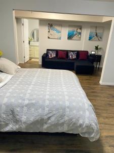 a bedroom with a large bed and a couch at Park side 2 Bed 2 Bath suite in Kelowna