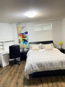a bedroom with a bed and a desk and a chair at Park side 2 Bed 2 Bath suite in Kelowna