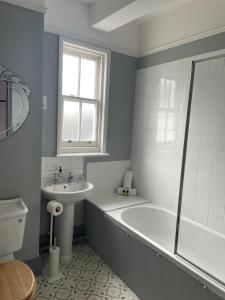 a bathroom with a bath tub and a sink at The Royal Oak in Hawkhurst