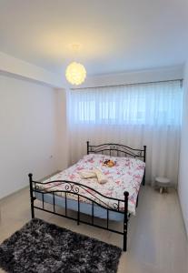 a bedroom with a bed and a chandelier at Select Apartment SIBIU in Sibiu