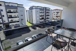 a balcony with a table and chairs and buildings at Select Apartment SIBIU in Sibiu