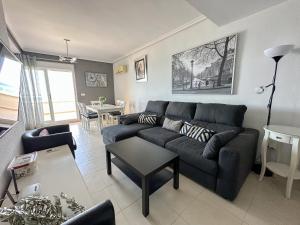 a living room with a couch and a table at Apartamentos Be Suites Primera Linea in Oropesa del Mar