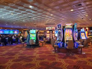 a casino with many slot machines in a room at Gold Coast Casino by the Strip Las Vegas in Las Vegas