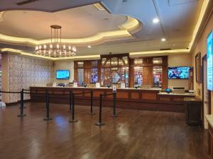 a large lobby with a bar in a casino at Gold Coast Casino by the Strip Las Vegas in Las Vegas