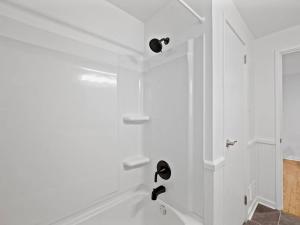 a white bathroom with a tub and a sink at Stylish and Modern 2Bdr Apartment in Millvale/Lawrenceville in Pittsburgh +11 photos