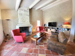 a living room with a couch and a fireplace at Chante Coucou in Saint-Saturnin-lès-Apt