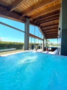 a swimming pool in a house with a view of the ocean at La Siègià Resort spa in Massa Marittima