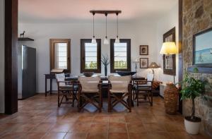a dining room with a table and chairs at Stone-Home Living in Neos Marmaras