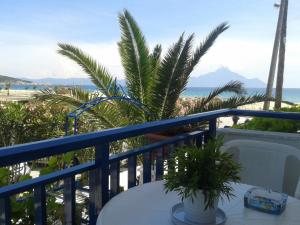 a balcony with a table and a view of the beach at Rudi Studios in Sarti