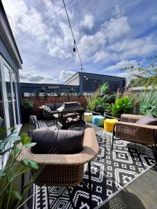 eine Terrasse mit Stühlen und einem Tisch auf der Terrasse in der Unterkunft Sandy feet retreat in Exmouth