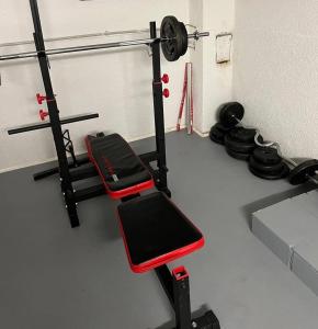 a room with a gym with a bench and weights at E & N Apartments in Oberhausen