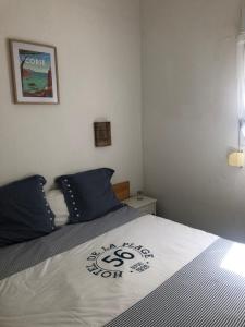 a bedroom with a bed with a sign on it at Altura in Zonza