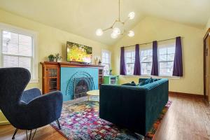 a living room with a couch and a fireplace at Pastel Palace - near Plaza & Uptown 23rd in Oklahoma City