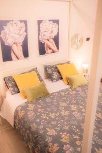 a bedroom with a bed and some pictures on the wall at Il Verdi home in Caserta