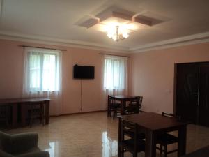 a living room with tables and a tv and windows at Shen toon guesthouse in Shnogh