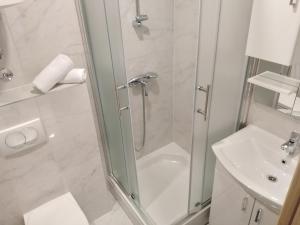 a bathroom with a shower and a toilet and a sink at Apartman Roko in Ploče
