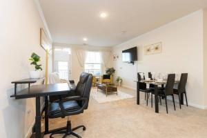 a living room with a table and chairs and a dining room at Elegant 2BR Suite in Downtown Waxhaw w. Pool 
