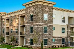 an apartment building with a brick at Elegant 2BR Suite in Downtown Waxhaw w. Pool 