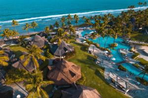an aerial view of a resort with a pool and the ocean at Summerville Resort - All Inclusive in Porto De Galinhas