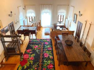 a living room with a wooden table and a dining room at Terra Petra Villa at Psari Trikolonon Gortynia in Psárion