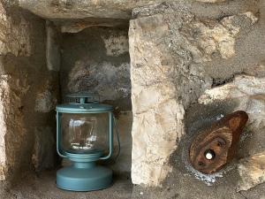 a blue toilet sitting in a stone cave at Terra Petra Villa at Psari Trikolonon Gortynia in Psárion