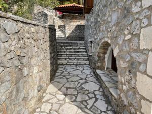 a stone wall with stairs and a stone stair case at Terra Petra Villa at Psari Trikolonon Gortynia in Psárion