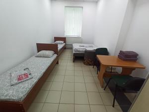 Postel nebo postele na pokoji v ubytování Старий Дворик,кімнати біля жд вокзалу