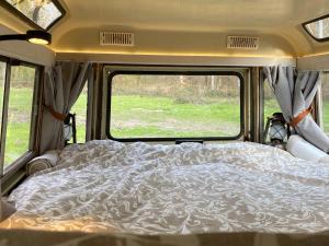 a bed in the back of a camper van at DEFCAMP in Rixensart