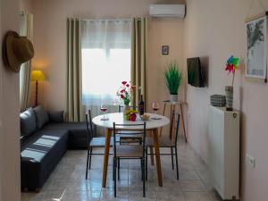 a living room with a table and a couch at Villa Kalliope in Keramoti +38 photos