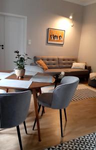 a living room with a table and chairs and a couch at Soul Apartment in Warsaw