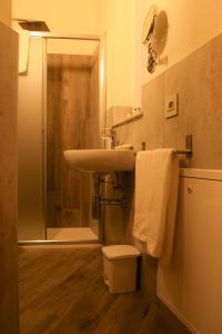 a bathroom with a sink and a shower and a toilet at B&B Da Nora in Mallare