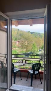 a screened in porch with two chairs and a view at B&B Da Nora in Mallare