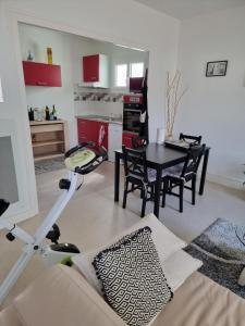 a living room with a table and a kitchen at Port de Riberou in Saujon