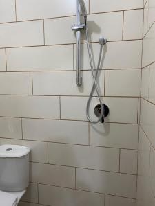 a shower in a bathroom with a toilet at North Gate Guest House and Camping in Shkodër